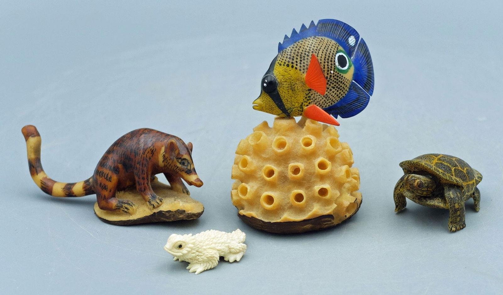 TRIO OF TAGUA NUT SCULPTURES -