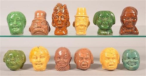 TWELVE POTTERY FIGURAL BUST STILL