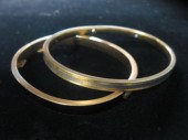 Two 14 karat yellow gold bangl