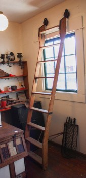 TWO ANTIQUE OAK ROLLING LADDER