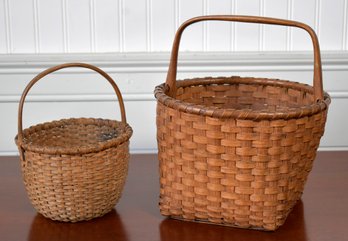 Two antique splint baskets, a