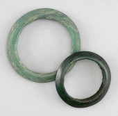 TWO ARCHAIC GREEN JADE BANGLES