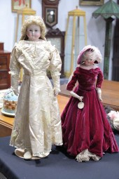TWO BISQUE HEAD DOLLS. Each wi