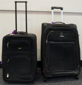 TWO BLACK VINYL ROLLING SUITCA