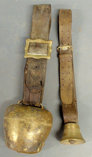 Two brass cow bells with leather