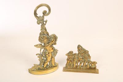 Two brass doorstops, the larger a