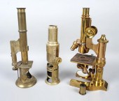 TWO BRASS MICROSCOPES AND AN E