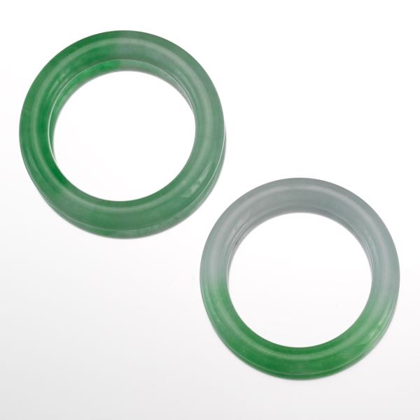 TWO CARVED JADE BANGLE BRACELETS 