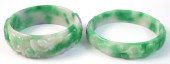 TWO CARVED JADE BANGLES. Both