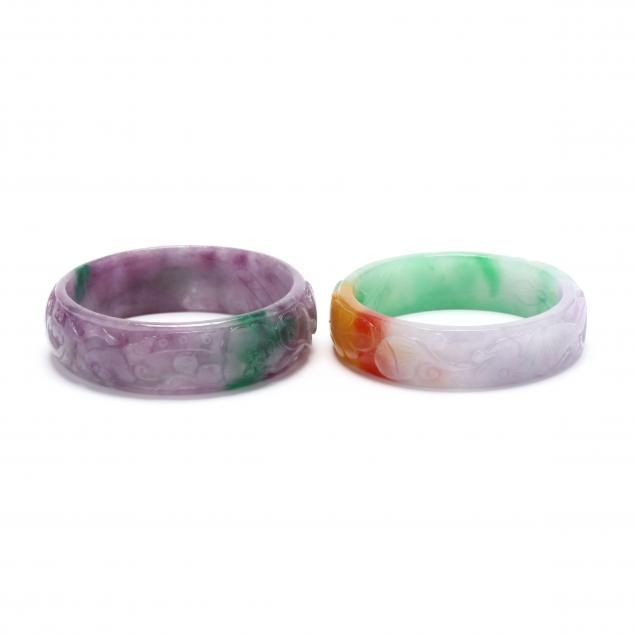 TWO CARVED JADE BANGLES To include: