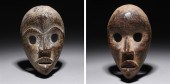 Two carved wooden masks in the