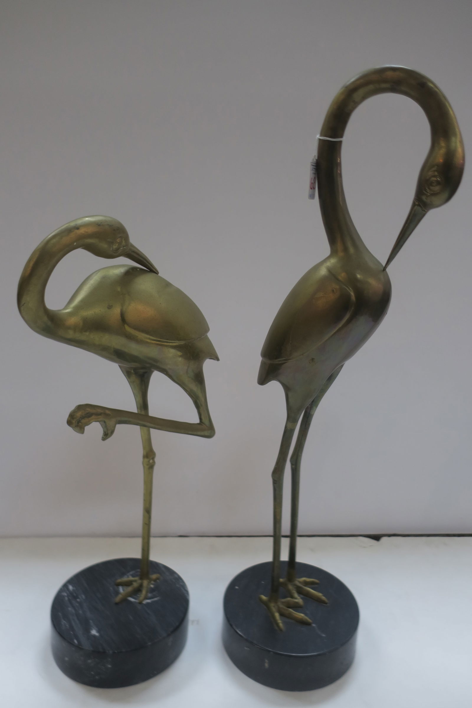 TWO CAST BRASS HERON FIGURES ON