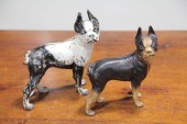 TWO CAST IRON DOG DOOR STOPS.