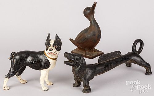 TWO CAST IRON DOORSTOPS,