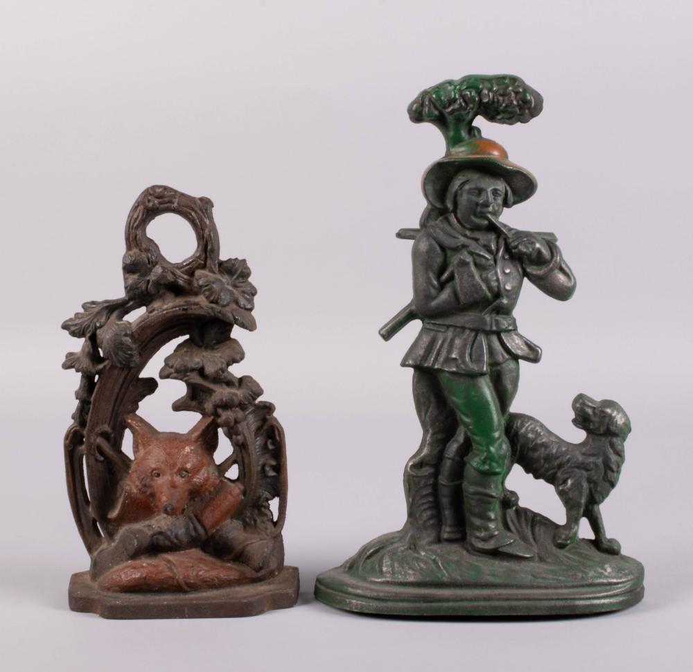TWO CAST IRON DOORSTOPS IN THE FORM