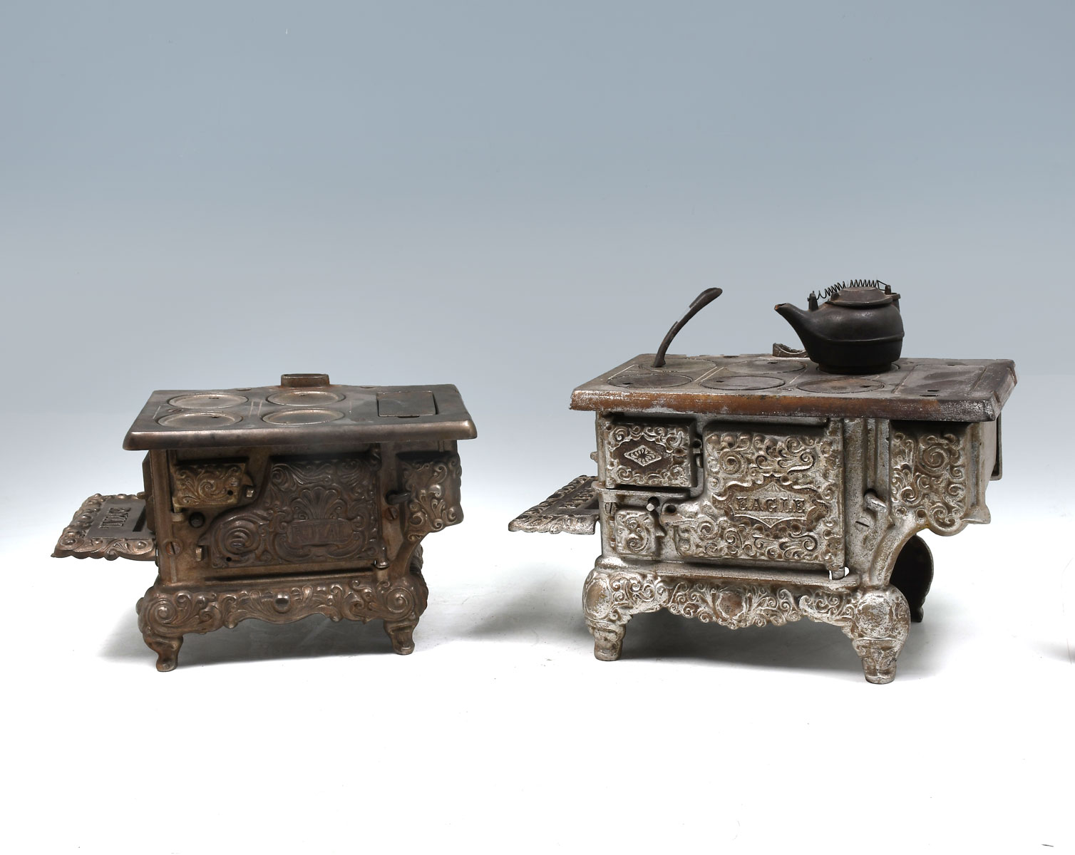 TWO CAST IRON MINIATURE STOVES:
