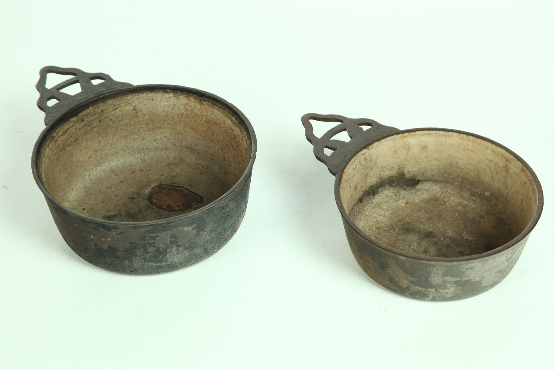 TWO CAST IRON PORRINGERS.  American