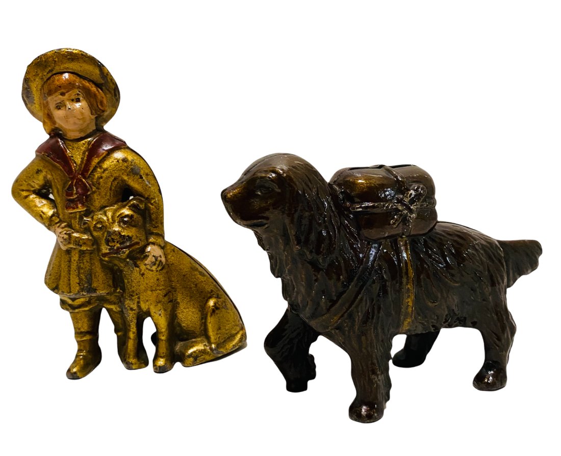 TWO CAST IRON STILL BANKS -