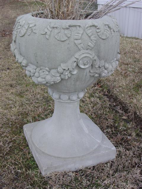 TWO CAST STONE PLANTERS ON STANDS