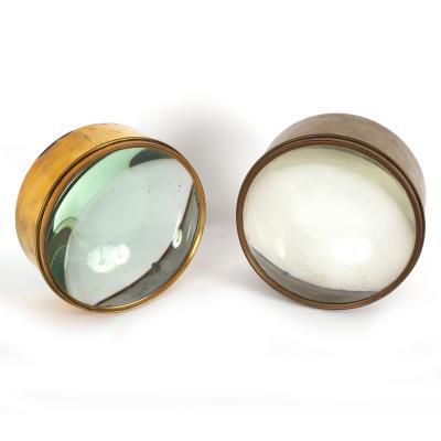 Two circular brass mounted