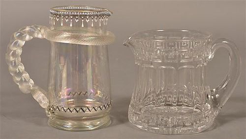 TWO COLORLESS GLASS PITCHERS.Two