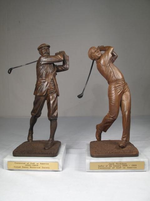 Two composition carved golfer