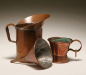Two copper measuring pieces an