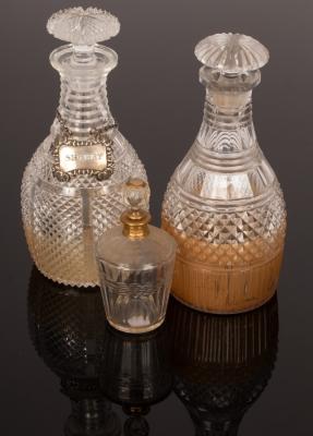 Two cut glass decanters, a silver