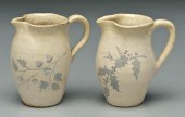Two decorated cream pitchers: