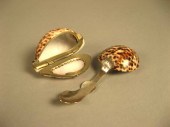 Two decorative Cowrie shell ta