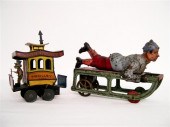 Two early 1900s tin toys: a bo