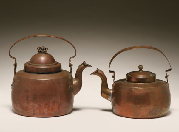 Two early copper teapots; both