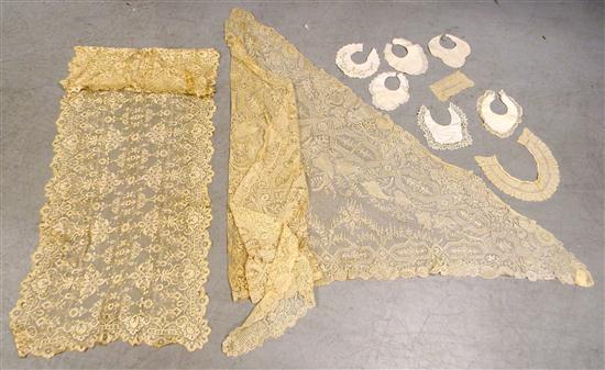 Two ecru lace shawls  some