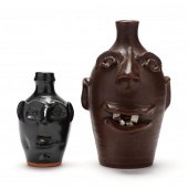 TWO FOLK POTTERY FACE JUGS, SE