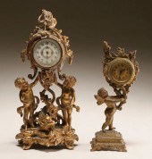 Two gilt metal cherub clocks;