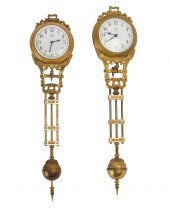 TWO GILT SWINGER CLOCKSmeant f