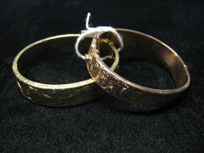 Two gold bangles etched with