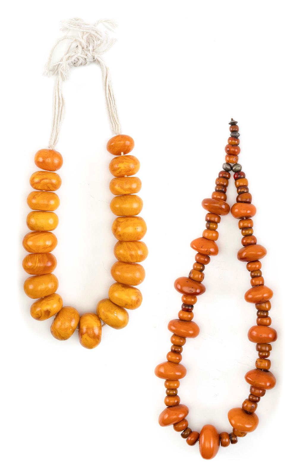 TWO GRADUATED CORAL AMBER NECKLACES