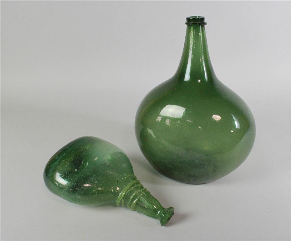 TWO GREEN GLASS BOTTLES the largest