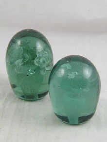 Two green glass dump paper
