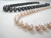 TWO HAND-KNOTTED COLORED PEARL