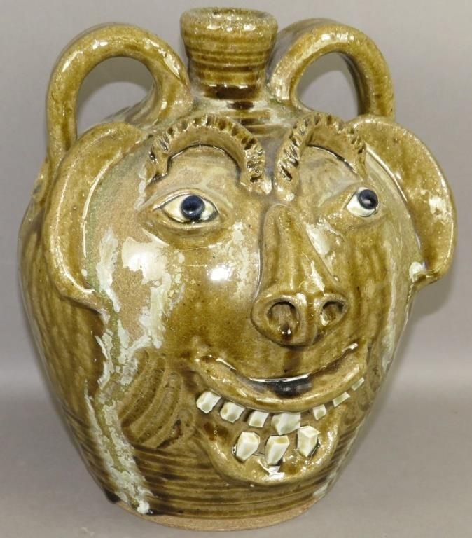 TWO HANDLED FOLK ART FACE JUG BY