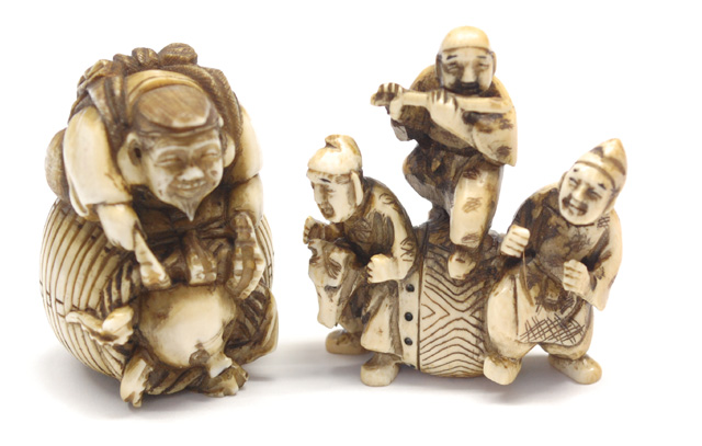 TWO IVORY CARVED NETSUKE: man