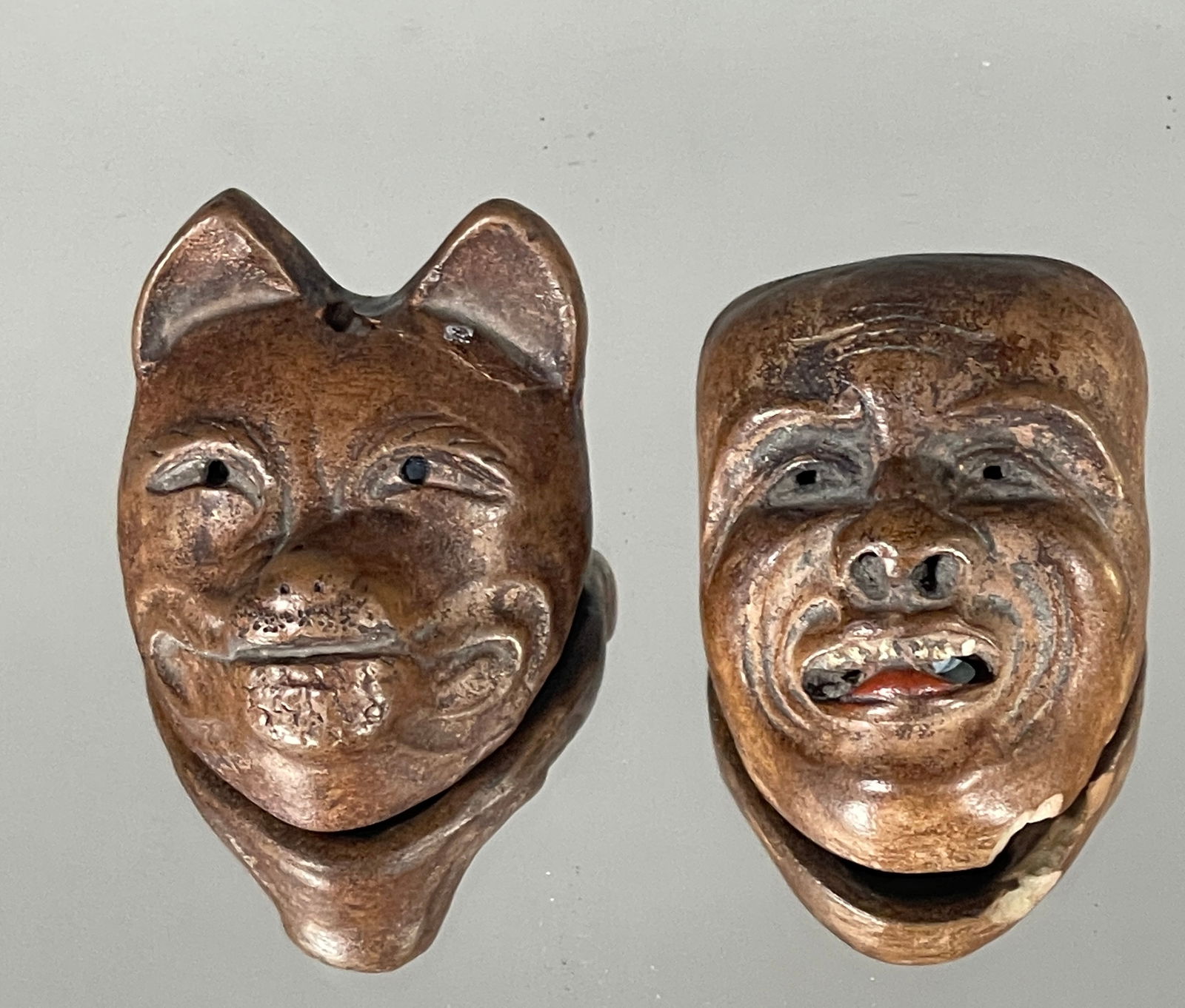 TWO JAPANESE NETSUKE1. Mask of a