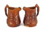 Two large ceramic pitchers wit