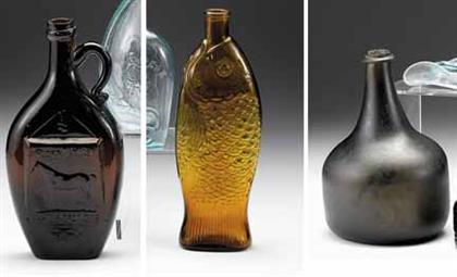 Two molded amber glass flasks and a