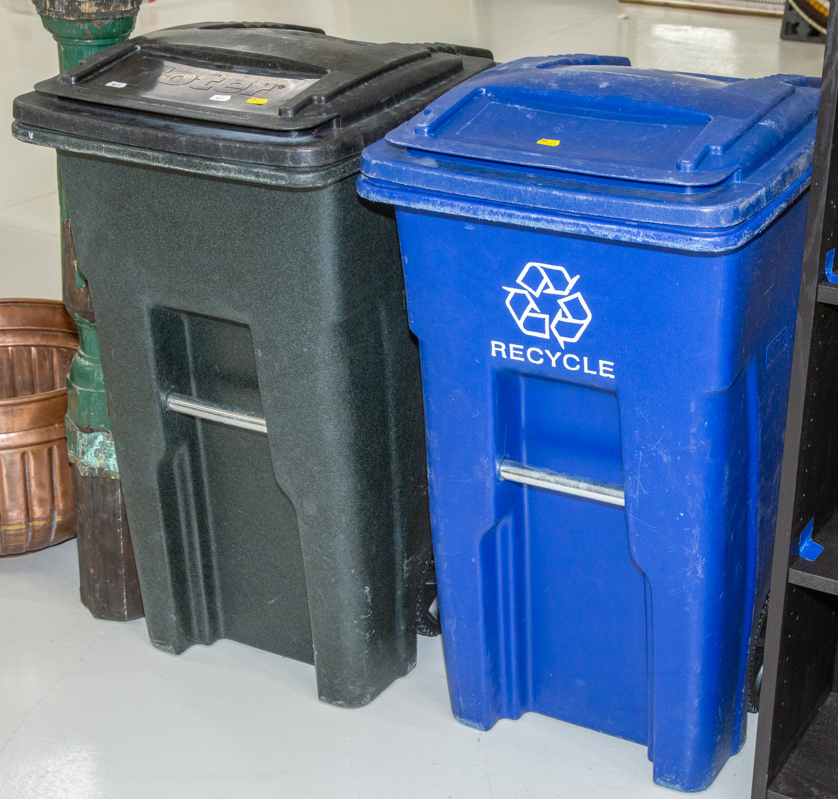 TWO OUTDOOR PLASTIC TRASH CANS .