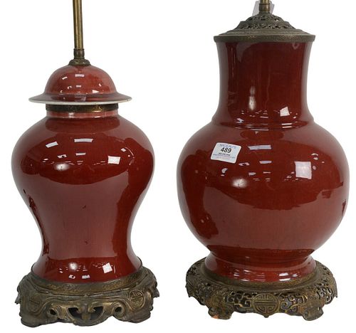 TWO OXBLOOD LANGYAO LAMPS, ONE IN