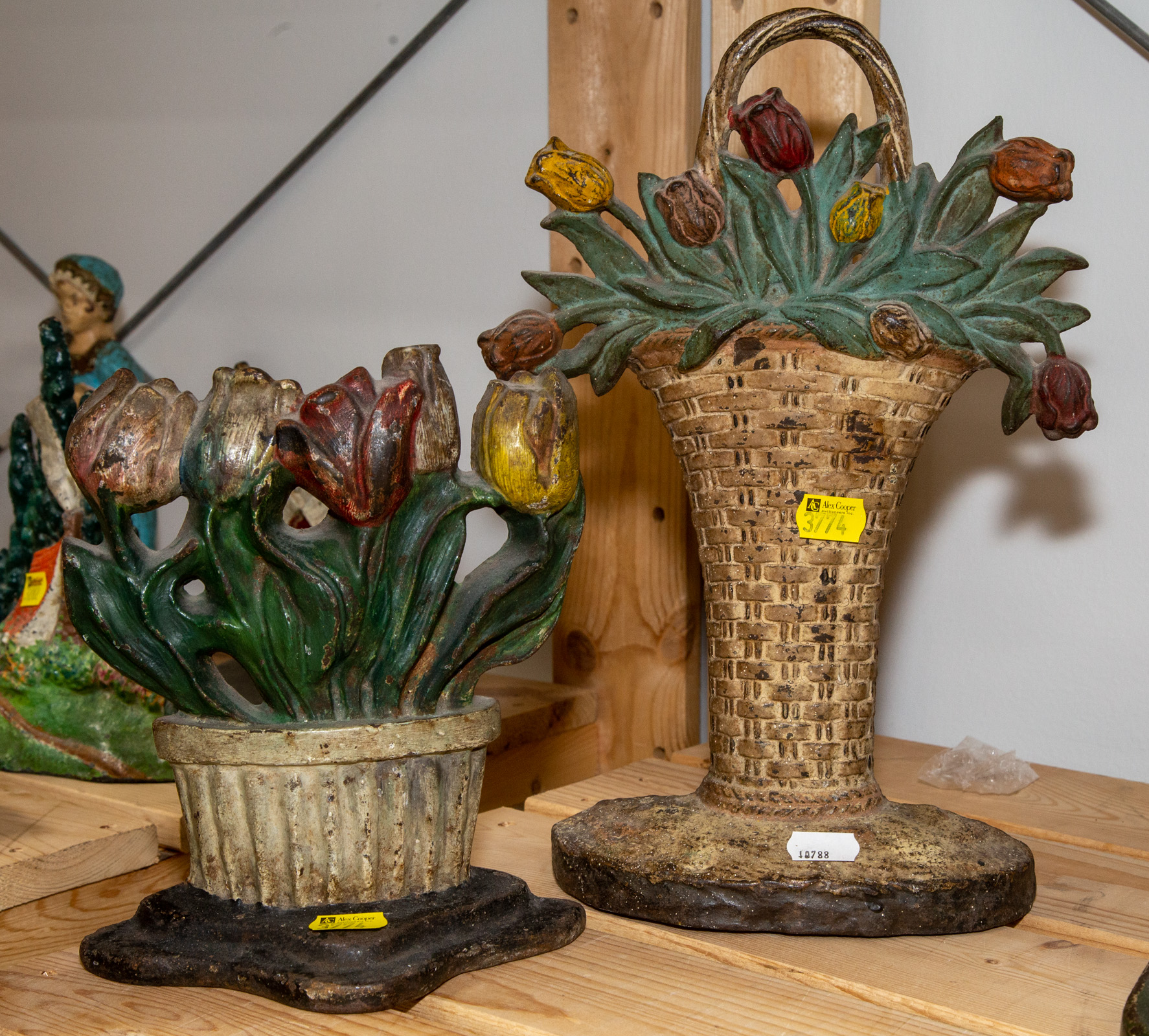 TWO PAINTED CAST IRON DOOR STOPS