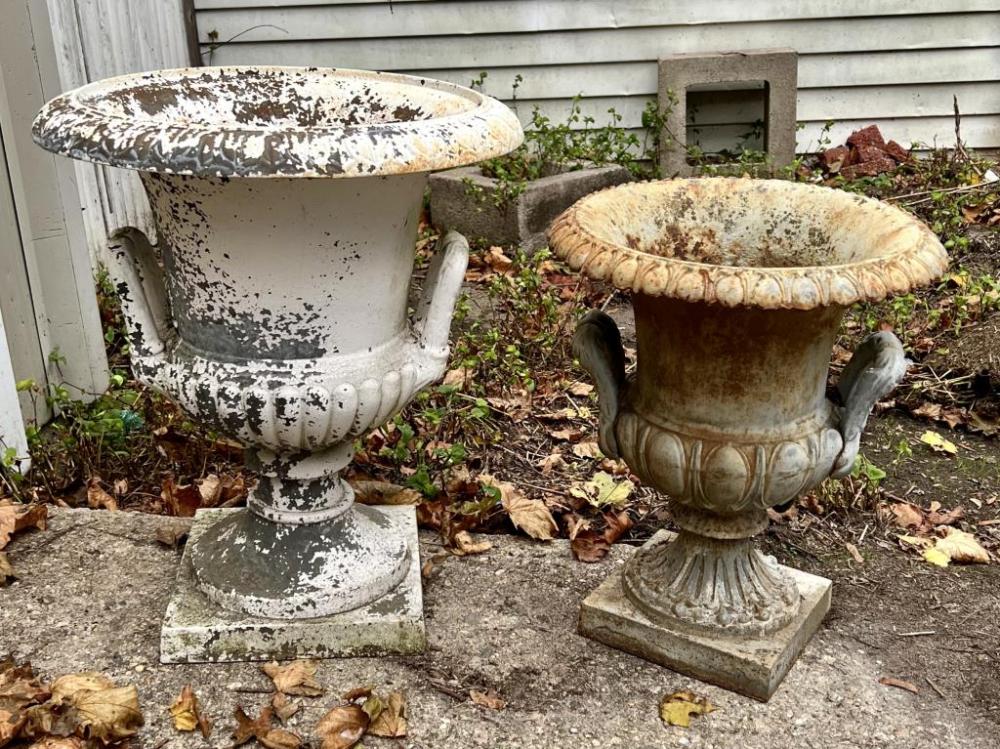 TWO PAINTED CAST IRON GARDEN URNS